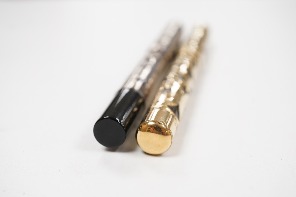 A Swan MT & Co. sterling silver filigree eyedropper along with similar gold filled example
